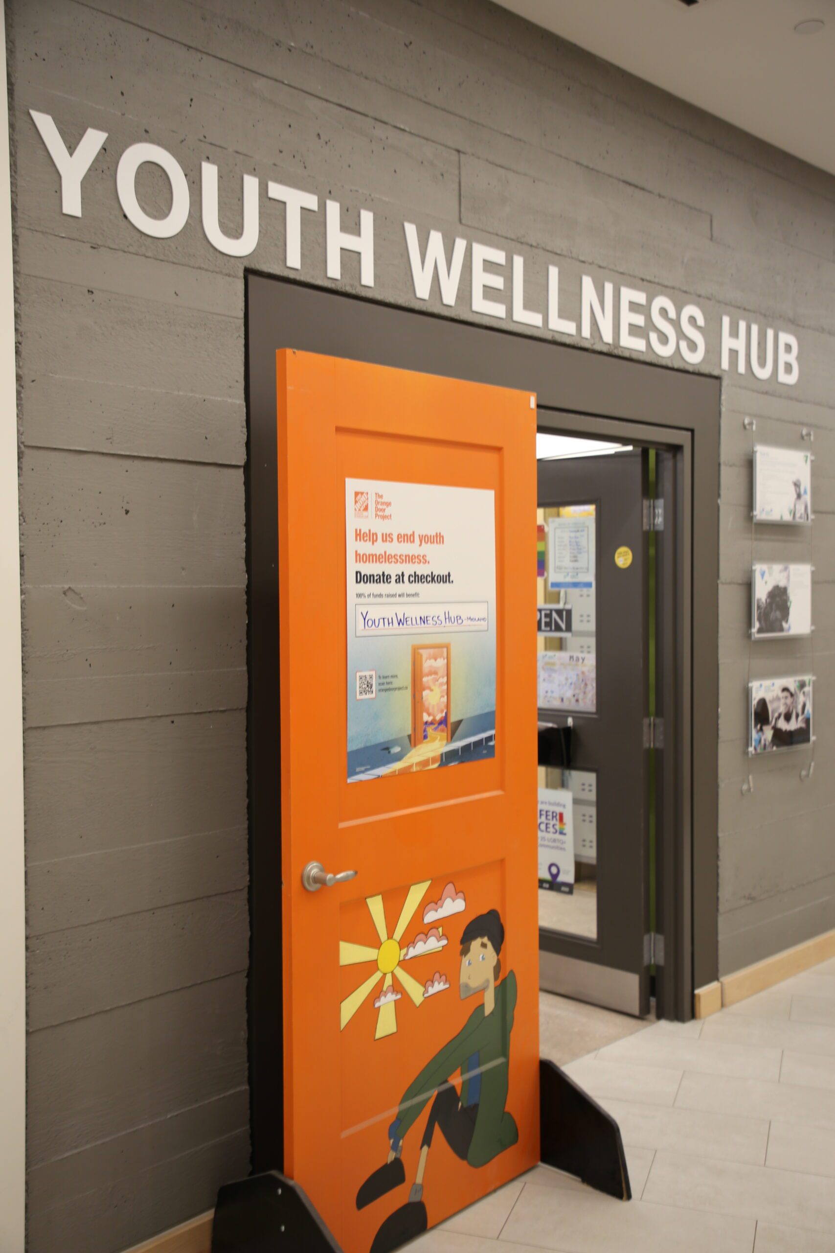The orange door outside of the youth hub
