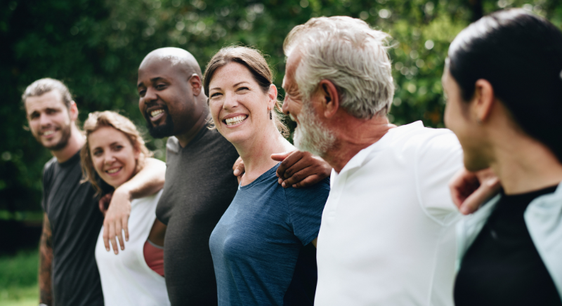 a group of six people smile at eachother