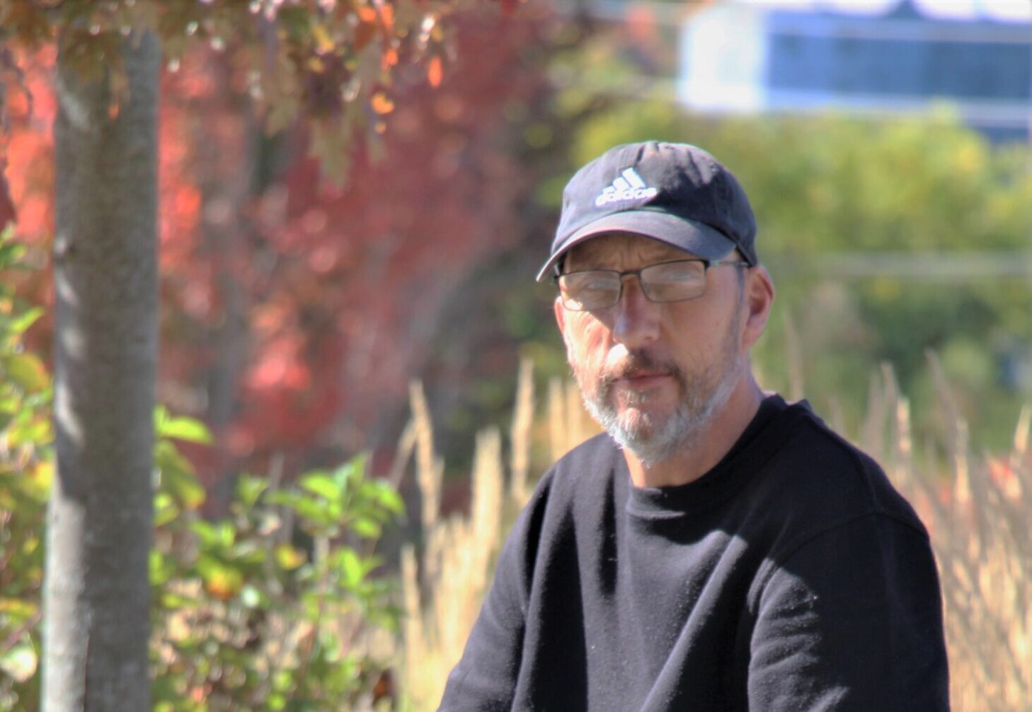 Adam sitting on a bench outside