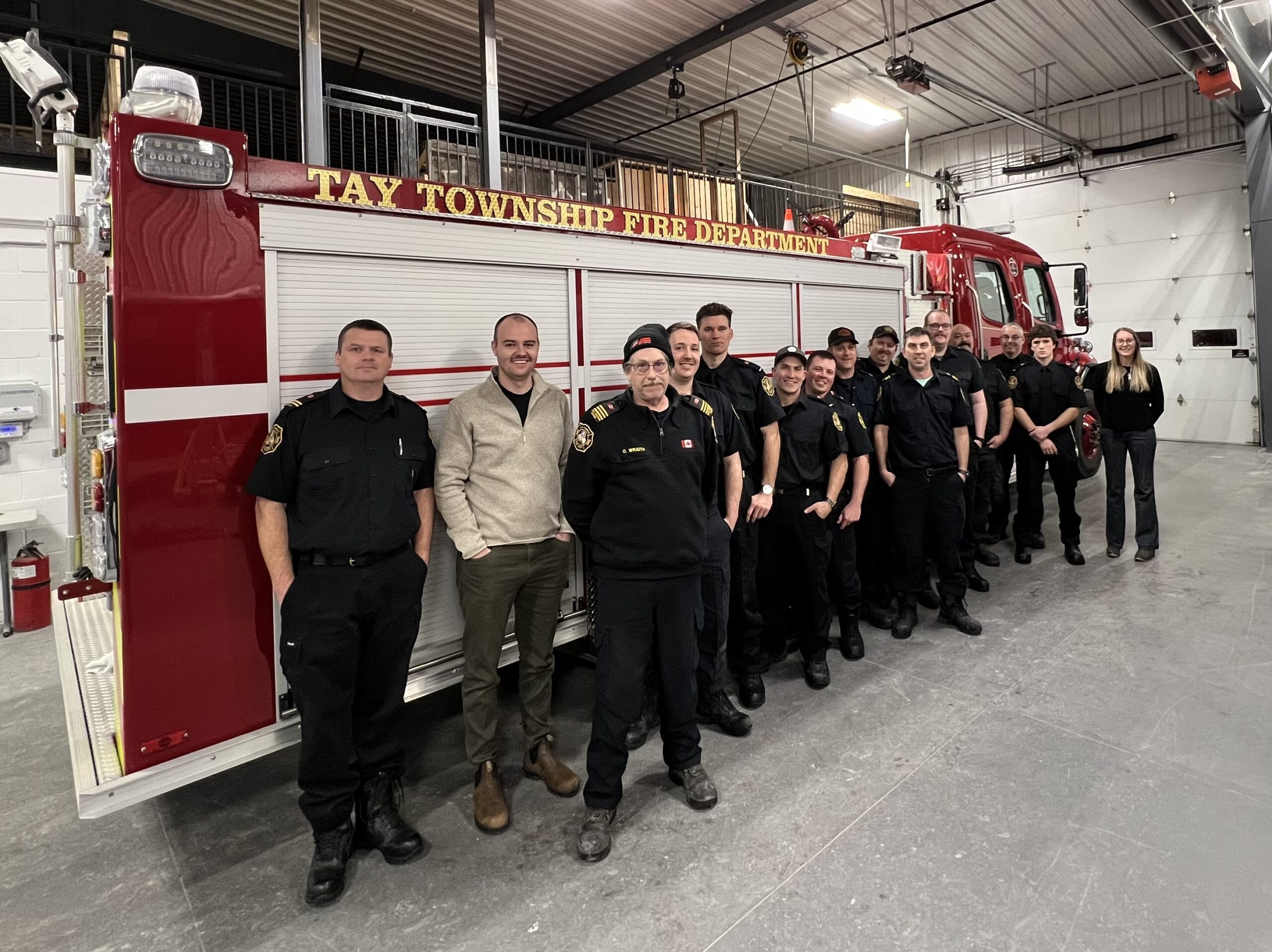 The Tay Fire fighters standing in front of one of their trucks with a member from Waypoint's Frontline Wellness program