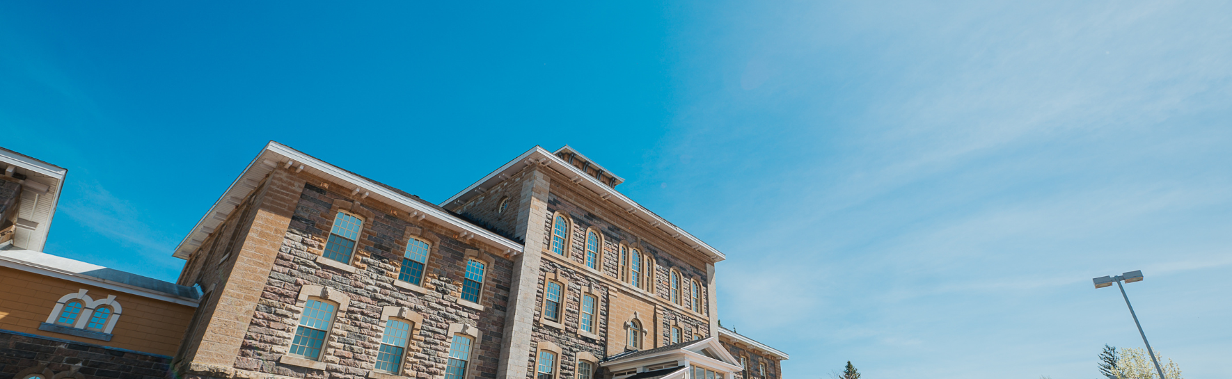 A view of the admin building looking up toward the blue sky