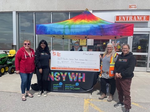 The NSYWH receiving their cheque from Home Depot
