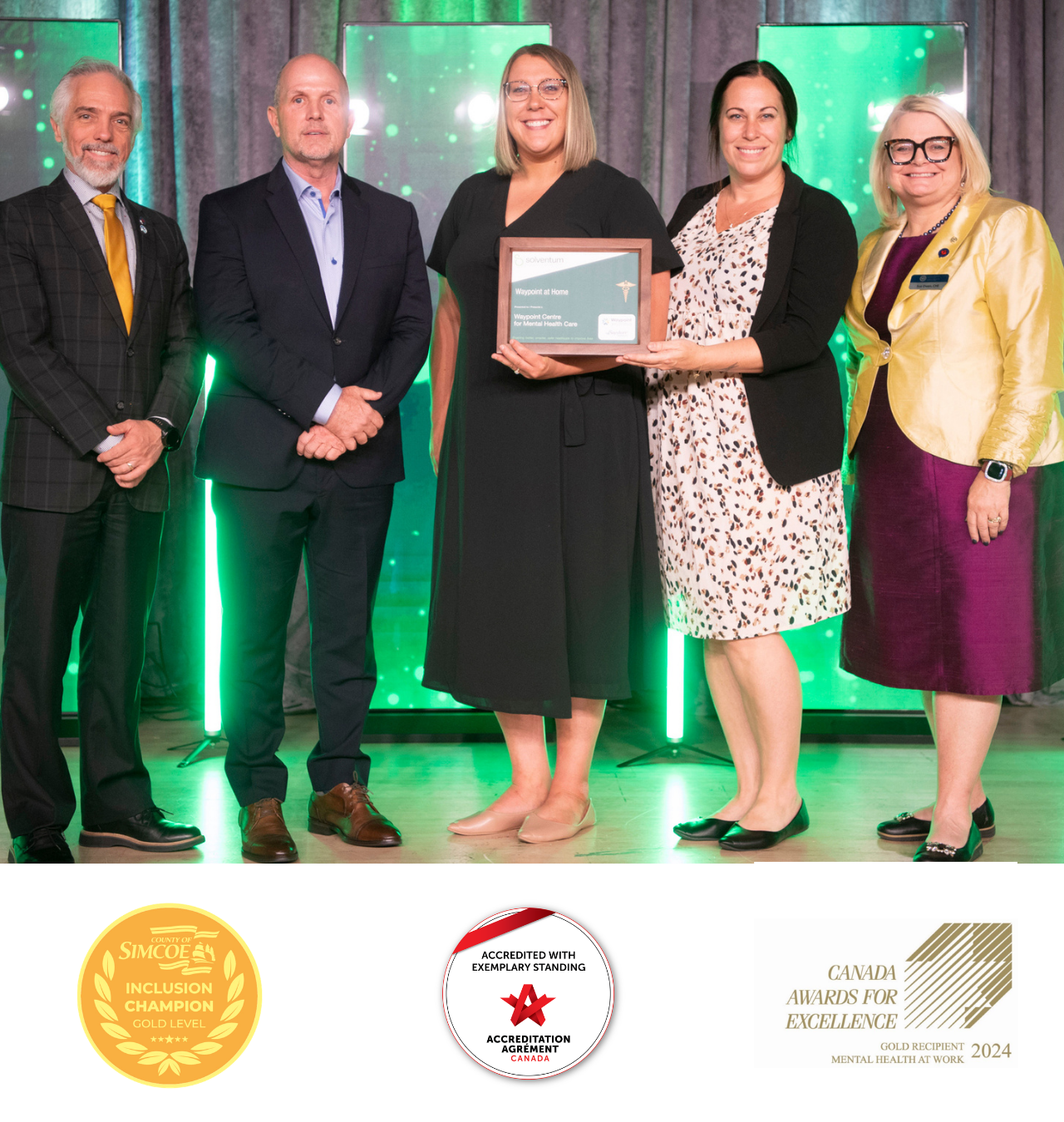 Waypoint staff accepting our CCHL award with the logos of three other awards we have won